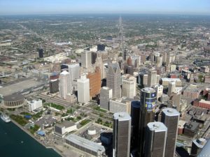 View of Detroit taken from a high view point, perhaps a helicopter. The buildings of downtown are prominently shown
